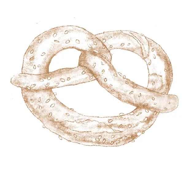 Ein Brezel in Knotenform mit dunklen Flecken auf der Oberfläche