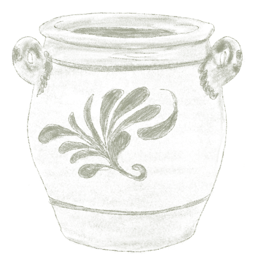 Un vase blanc avec des anses et un motif floral vert