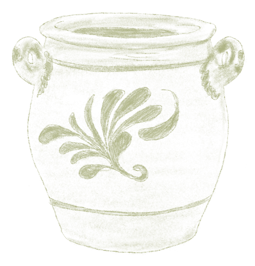 Ein weißer Keramiktopf mit Henkeln und einem grünen floralen Muster